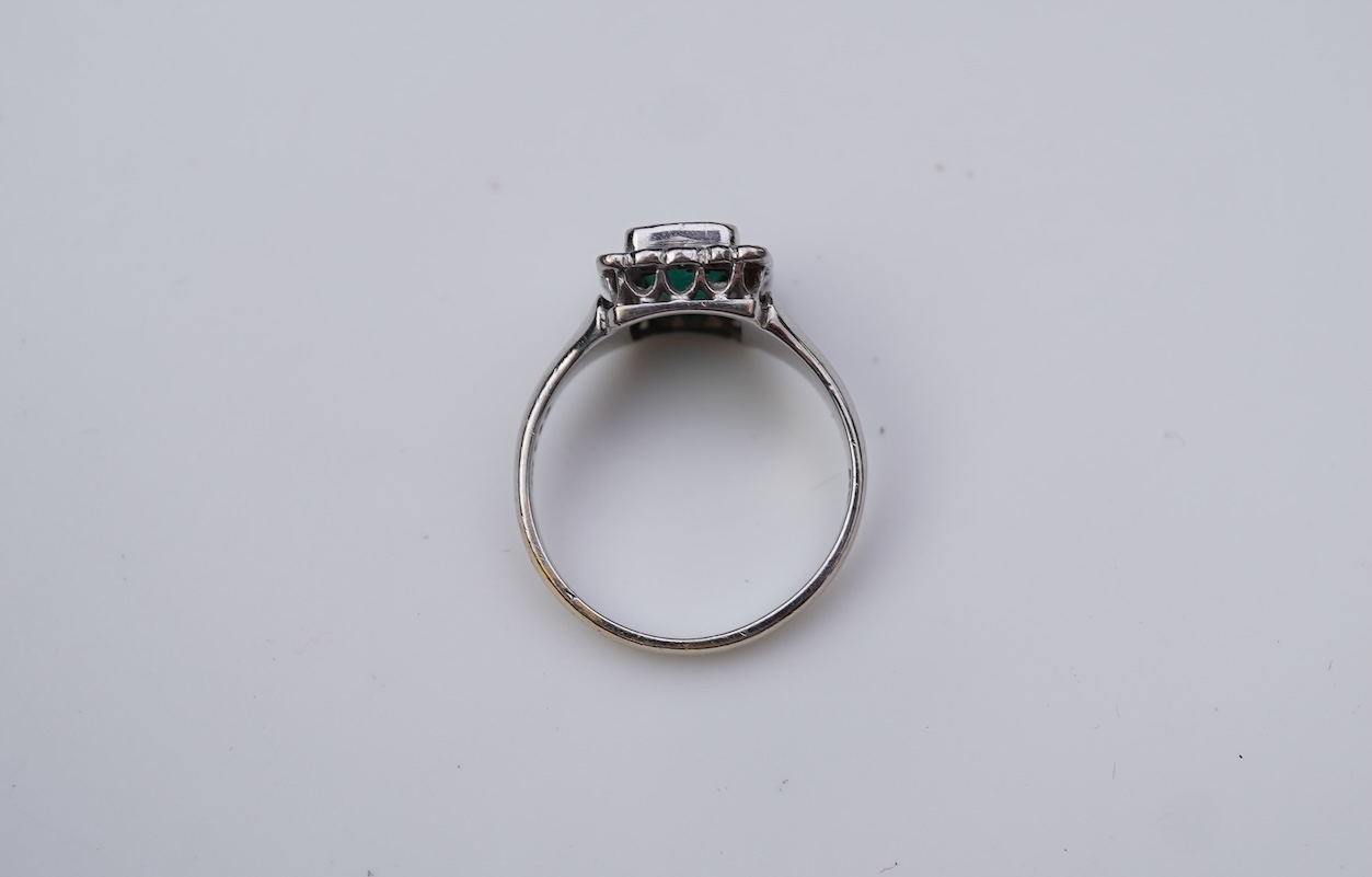 An emerald and diamond ring
